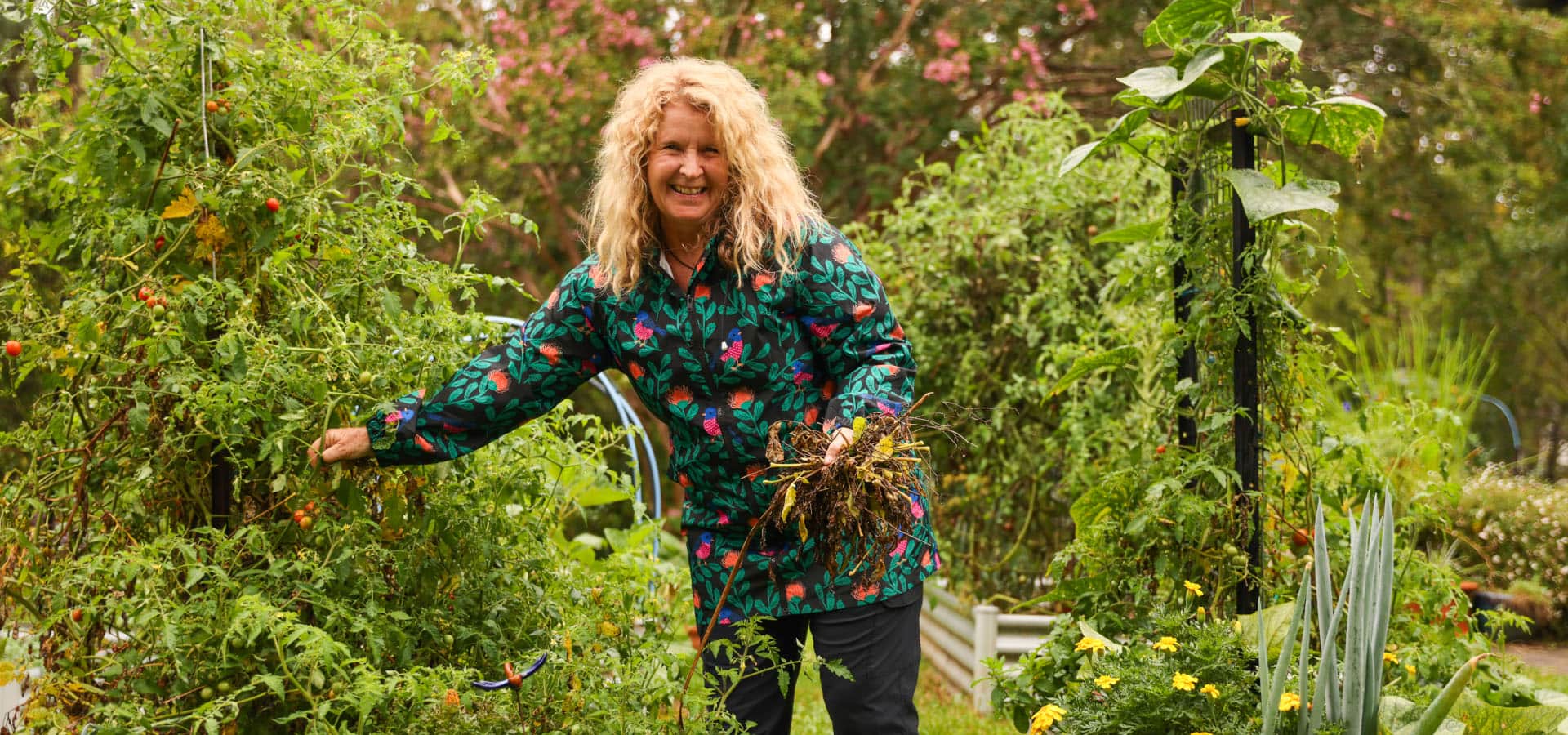 Kerrie stands near tomato plants